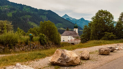 Fototapeta na wymiar Alpine summer view with a church near Graen, Tannheimer Tal valley, Reutte, Tyrol, Austria