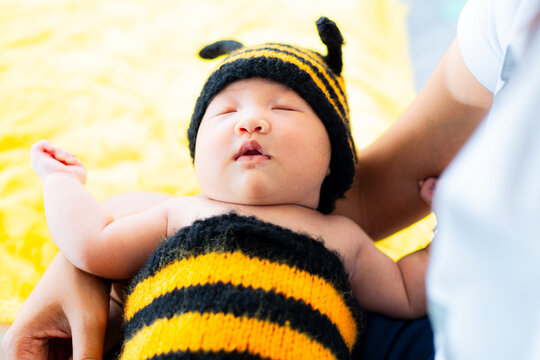 Asian Baby Girl dress in a bee costume,baby in bee costume,newborn baby in bee costume. newborn baby concept shot,