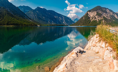 High resolution stitched alpine summer panorama with reflections near Lake Plansee, Reutte, Tyrol,...
