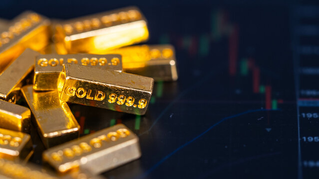 Gold Bars Place On The Phone That Opens The Candlestick Chart. Fluctuations In Gold Prices Concept.