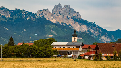 Obraz premium Alpine summer view with a church near Tannheim, Tannheimer Tal valley, Reutte, Tyrol, Austria