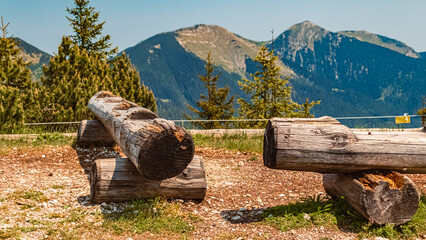 Alpine summer view with details of wooden benches at Mount Wank, Garmisch-Partenkirchen, Bavaria,...