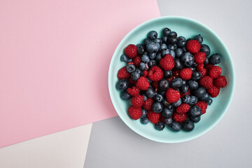 Plate with delicious raspberry strawberries and blueberries on a light background. Fresh organic berries and fruits. Farm ecological product. Without GMO. Fresh vitamins 