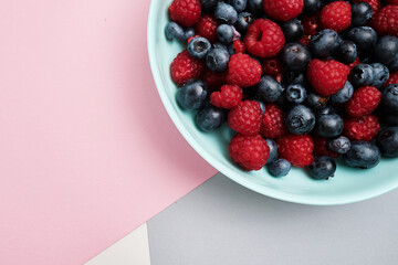 Plate with delicious raspberry strawberries and blueberries on a light background. Fresh organic berries and fruits. Farm ecological product. Without GMO. Fresh vitamins 