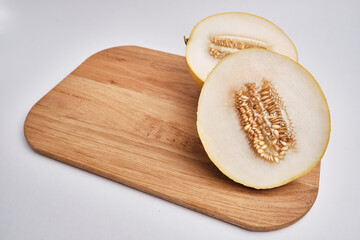 Slices of juicy melon on a light background. Organic summer fruits. The concept of food, health, nutrition