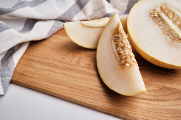 Slices of juicy melon on a light background. Organic summer fruits. The concept of food, health, nutrition
