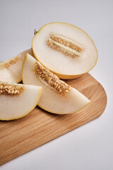 Slices of juicy melon on a light background. Organic summer fruits. The concept of food, health, nutrition
