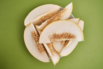 Slices of juicy melon on a light background. Organic summer fruits. The concept of food, health, nutrition