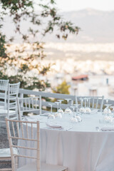 Served table with glasses at sunset. Romantic date in the restaurant.  