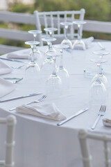 Served table with glasses at sunset. Romantic date in the restaurant.  