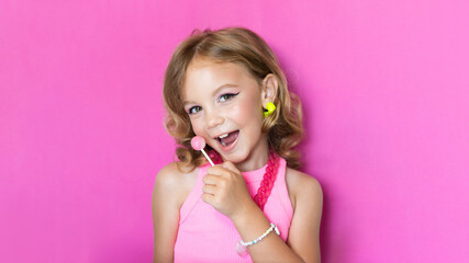 Cute girl with makeup in pink clothes, image in the style of Barbie. Trend for girls, portrait on...