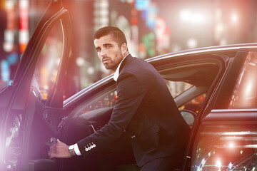 Portrait of an elegant man driving a car, luxury nightlife,.