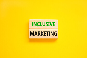 Inclusive marketing symbol. Concept words Inclusive marketing on beautiful wooden block. Beautiful yellow table yellow background. Business inclusive marketing concept. Copy space.