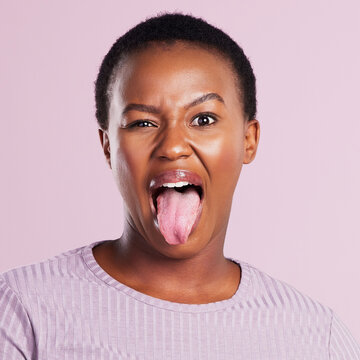 Woman, eye and tongue in pink studio background with emoji in africa with closeup. Female person, face and meme with funny expression with eyes and open mouth for comedy, joy and goofy girl in youth.