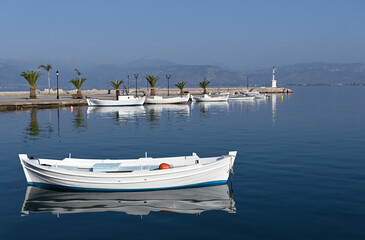 Fototapeta na wymiar White boats and blue sea in the harbor Nafplio Greece
