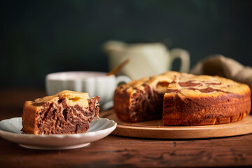 Chocolate and Vanilla Zebra Pie with piece cut off on plate. Homemade marble cake chocolate