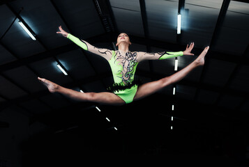 Woman, jump and gymnastics with fitness and competition, action and body with performance in arena....