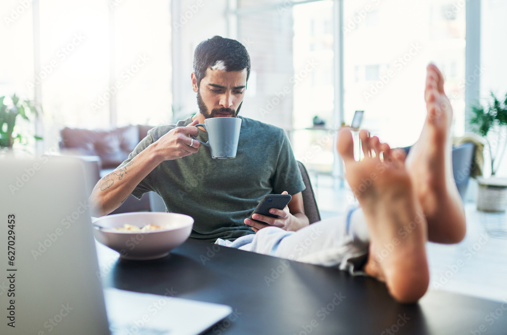 Aufkleber i have a lot in my feed. shot of a man using his cellphone while having breakfast at home.