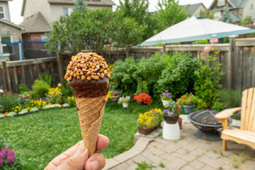 Ice cream in a waffle cone against flowers
