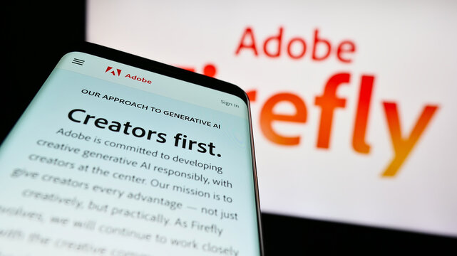 Stuttgart, Germany - 07-15-2023: Mobile phone with website of generative AI product Adobe Firefly on screen in front of business logo. Focus on top-left of phone display.