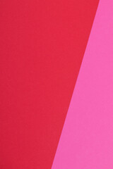 Multicolor background from a paper of different colors. Mix of pink and red colors. Geometric backdrop.