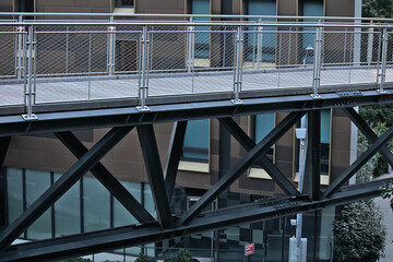 pedestrian walkway with rails elevated above street with iron bars (urban architecture)