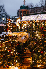 Vintage golden masquerade mask with glitter hanging on the Christmas tree. Winter holiday magic...