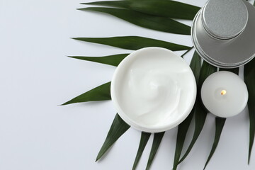 A jar of natural cosmetic face or body cream on a green leaf. Natural, bio cosmetics from herbs and plants for skin