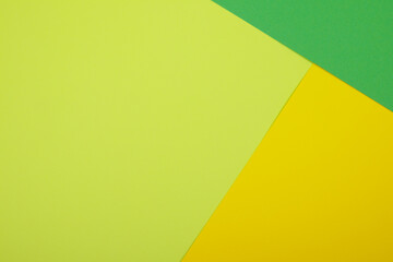 Multicolor background from a paper of different colors. Mix of yellow, green and lime colors....
