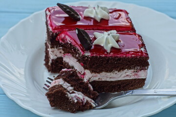 delicious fresh red  color with white and brown  cream fragrant sweet sliced cake from a pastry...