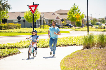 father and son on bicycle at fathers day. father setting a example for fathers son. fathers parenting with son outdoor. childhood of son supported by fathers care. Finding joy in family activities