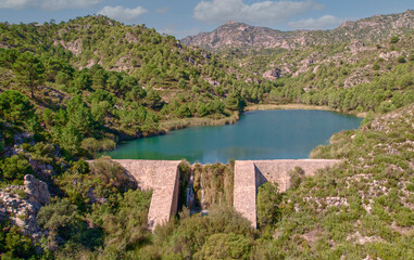Obraz na płótnie Canvas Reservoir at full capacity. Aerial view of a water reserve for human use. Water reserves for human consumption. Andalusia. Spain.