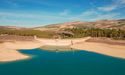 Poster Drought in the reservoir. Very low water reserves due to the effects of climate change. Aerial view. Empty reservoir. Granada. Spain. © Siroco Drones