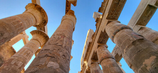 Columns of hypostyle room ceiling with Egyptian hieroglyphics. Karnak temple. Luxor. Egypt