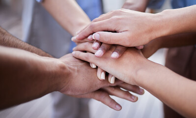Teamwork, hands and people in collaboration, support and circle of trust for motivation together. Closeup, community and helping hand of group, volunteers and goals for success, mission and synergy