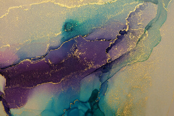 Watercolor and alcohol ink smoke flow stain blot on paper background. Beige, blue and gold colors. Marble texture.