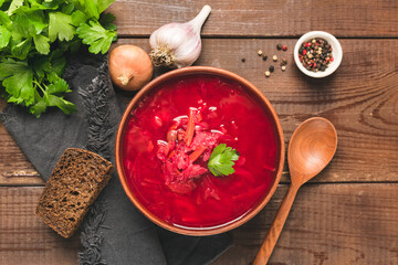 Borscht soup, traditional Ukrainian food. Beetroot soup on a wooden table, top view