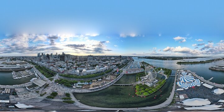 360 aerial photo taken with drone of the Ferris Wheel (La Grande Roue), the Cirque du Soleil tents, and Old Port next to the Saint Lawrence River in Montreal, Canada