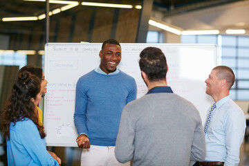 Sharing his vision. Cropped shot of a group of businesspeople talking in the boardroom.