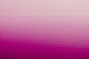 Pink sea water surface texture for background with colour gradient. Abstract nature image.