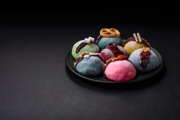 Delicious sweet colorful mochi desserts or ice cream with rice dough and toppings