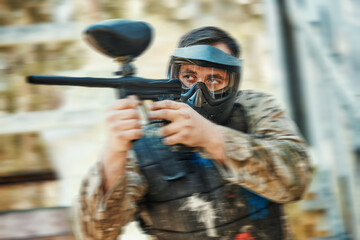 Fototapeta premium Paintball gun, focus and man aim, shooting and target soldier, action warrior or training for battlefield fight conflict. Army mission gear, blur and male shooter in war, battle or military practice