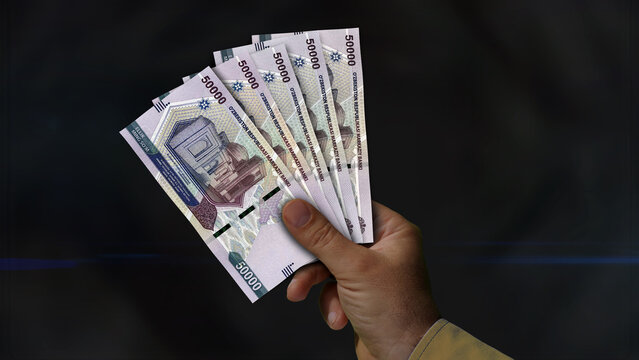 Uzbekistan Sum growing pile of money in hand concept 3d illustration