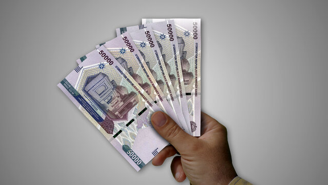 Uzbekistan Sum growing pile of money in hand concept 3d illustration