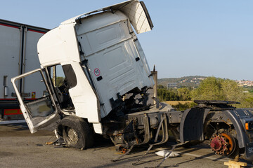 A truck damaged in an accident parked in a parking lot