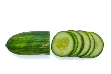 Top view of chopped cucumber slices on white isolated background