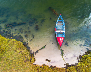 an old colorful boat alone in the sea. image of tranquility