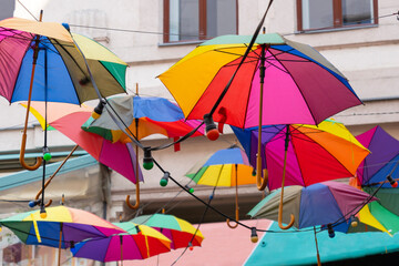 A street decorated with colorful lanterns and umbrellas in Budapest, Hungary