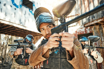 Paintball game, gun or team focus on shooting competition, challenge or military mission, arena practice or conflict. Target aim, soldier teamwork or people in survival war, action or battle training