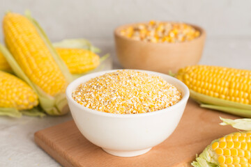 Corn groats and seeds with fresh cobs on wooden table